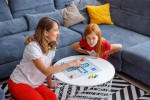 mother and daughter having fun playing ludo board game